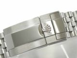 a close up of a watch bracelet on a white surface