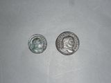 two silver coins sitting next to each other on top of a table