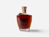 a bottle of brandy sitting on top of a white surface