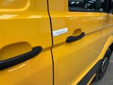 a close up of a yellow van with a sticker on it