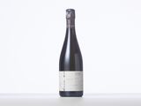 a bottle of wine sitting on top of a white table
