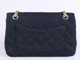 a black quilted purse with gold hardware on the handle