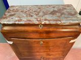 a wooden chest with a marble top on it