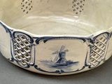 a blue and white bowl with a windmill on it