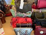 a lot of purses on a table in a store