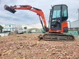a small excavator that is sitting in the dirt
