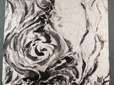 painting of a black and white swirl on a canvas on a table