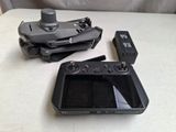 two remote controls and a tablet on a table