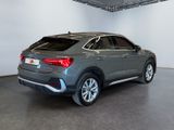 the rear end of a grey suv parked in a showroom