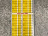 a close up of a yellow sign on a cement floor