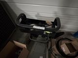 a box with a handlebar attached to it and a box with a handlebar attached to it in front of a garage door