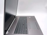 a silver laptop with a black keyboard on a white surface