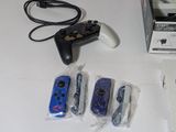 four video game controllers sitting next to each other on a table
