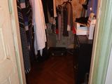 a closet with a lot of clothes hanging on it