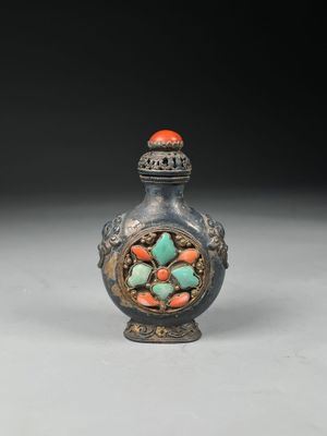 an old silver and turquoise glass snuffling bottle with a flower decoration on it