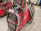 two welding machines that are sitting in the garage