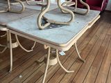 a table that has a bunch of chairs on it