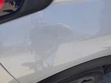a white car with a red sticker on the side of it