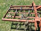a tractor plow that is sitting in the grass