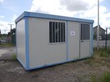 an image of a portable building in the middle of a parking lot