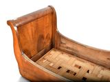 a wooden bed with a wooden sleigh on top of it