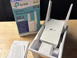 an image of a wireless router sitting on top of a table next to a box