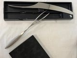 a pair of scissors, a book, and a pair of scissors on a table