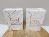 two boxes of kel yea perfume sitting on top of a wooden table