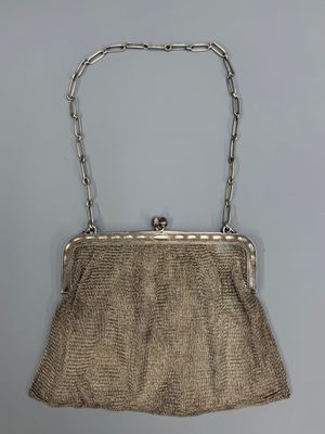 an antique silver mesh purse with chain handles