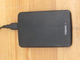 a black power bank sitting on a wooden table