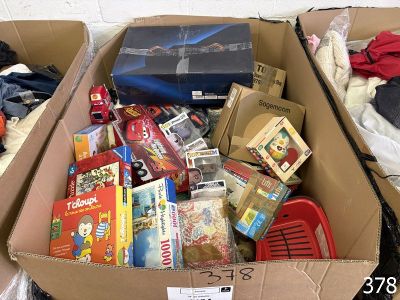 a cardboard box filled with toys and other items