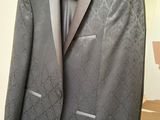 a suit and tie hanging on a hanger in front of a mirror