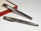 two pens sitting next to each other on a table