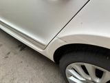 a car that has a broken door handle on the side of the road