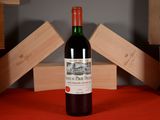 a bottle of red wine sitting on a table