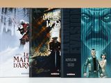 trois livres posés sur une table