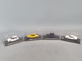 three toy cars are in a display case on a table