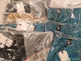 several pairs of men ' s underwear wrapped in plastic bags on a table