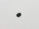 a green tourmaline stone on a white surface