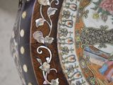 a close up of a decorative plate with flowers on it