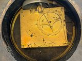 a yellow piece of metal in the middle of a hole