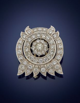 a diamond and gold broochle, by van cleef