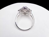 a picture of a diamond ring on a white surface