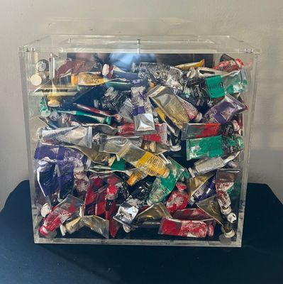 a clear box filled with assorted candy on a table