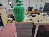a large green container sitting on top of a desk