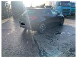 a black car that is parked in a parking lot