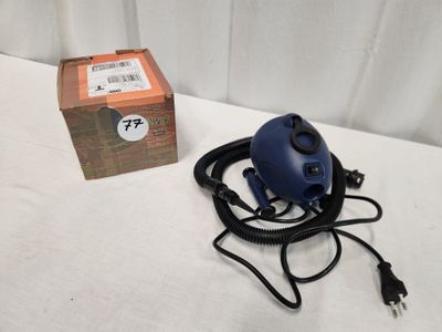 a blue blow dryer sitting on a table next to a box