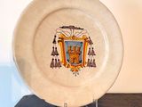 a plate with a picture of a coat of arms on it