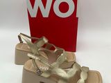 a close up of a pair of women ' s sandals with a box in the background