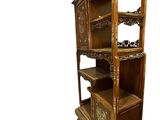 a wooden bookcase with many shelves on top of it
